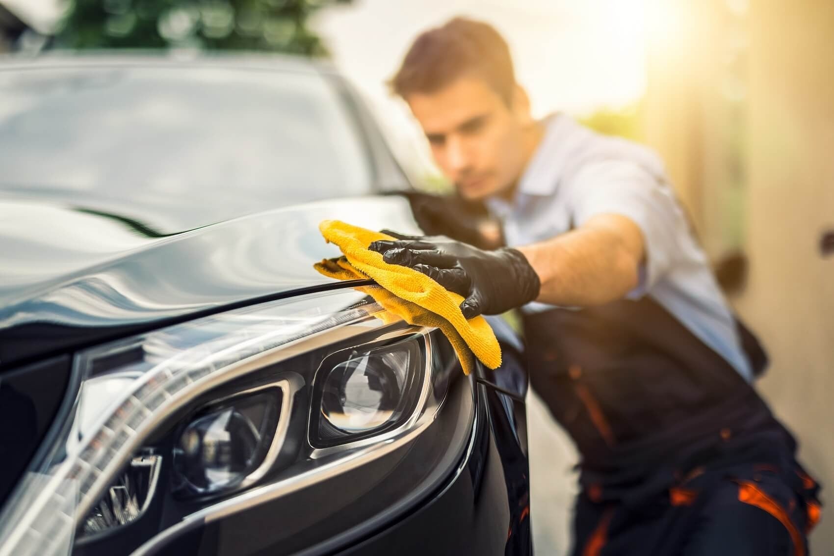image of a man wiping a car